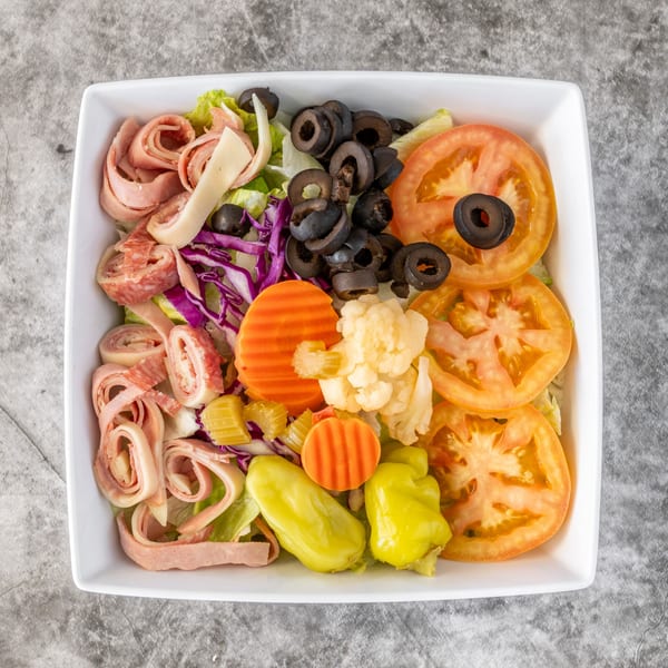 Ameci Pizza & Pasta's antipasto salad with meats, cheeses, olives, tomatoes, and pickled vegetables.